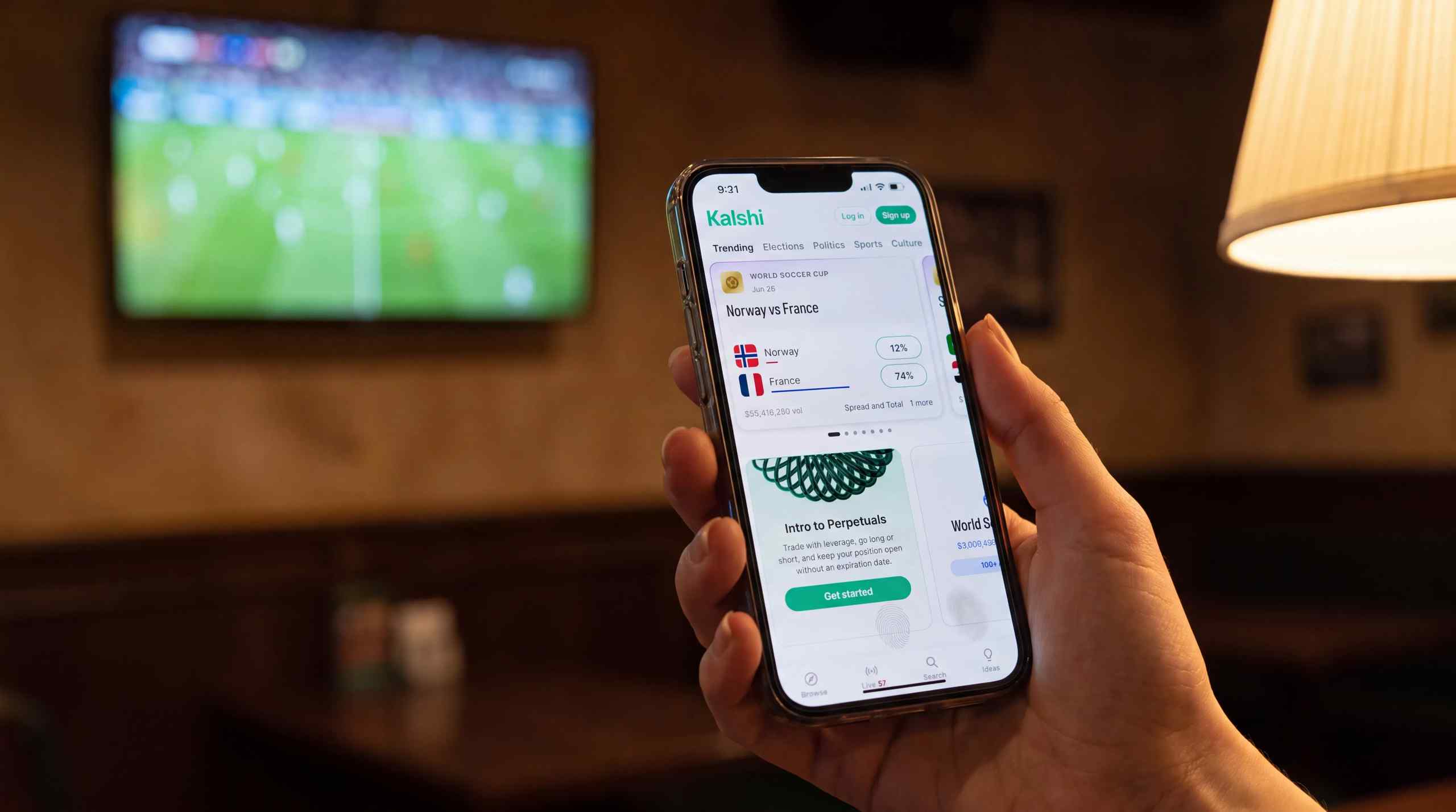 Someone watching soccer at home and checking the score on their smartphone.